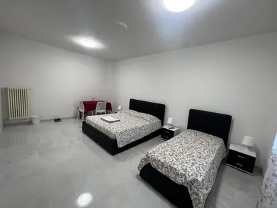 Letto o letti in una camera di Casa Roma rooms&apartments