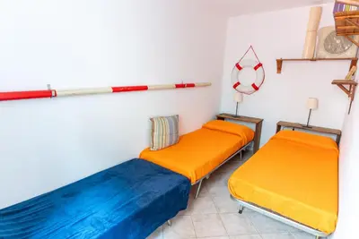 Letto o letti in una camera di Casa Aprilia by Ca-Sa Check