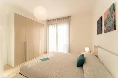 Letto o letti in una camera di Sun Beach Residence con Piscina - Piazza Brescia - Adria Holiday Jesolo - FAMILY APARTMENTS