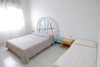 Letto o letti in una camera di Bagni Miramare Apartments