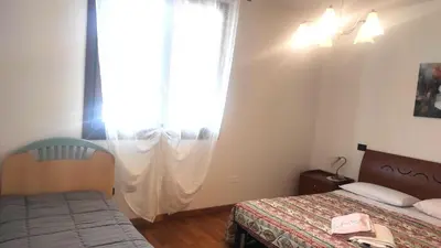Letto o letti in una camera di Appartamento LA PERLA