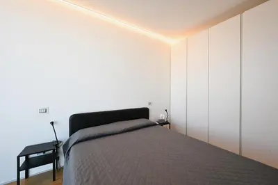 Letto o letti in una camera di Torre Aquileia Apartments