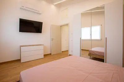 Letto o letti in una camera di APPARTAMENTI CAVALLINO-TREPORTI
