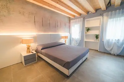 Letto o letti in una camera di BATTISTI HOSPITALITY - si, viaggiare