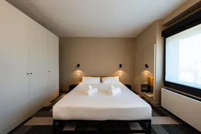 Letto o letti in una camera di BASALTO Venice Mestre Apartments