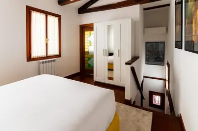 Letto o letti in una camera di Tintoretto Cozy Duplex R&R
