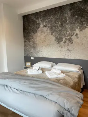 Letto o letti in una camera di PIO X Apartments Treviso