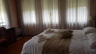 Letto o letti in una camera di Villa Lussana