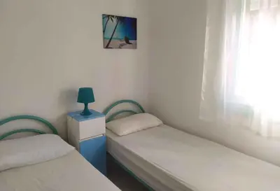 Letto o letti in una camera di Apartments in Rosolina Mare 25001
