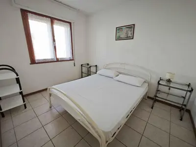 Letto o letti in una camera di Apartments in Rosolina Mare 25012