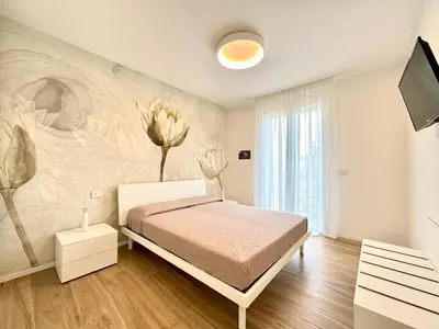 Letto o letti in una camera di Sun Village-Nuovissimo Appartamento in Residence con piscina -Lido di Jesolo Piazza Aurora