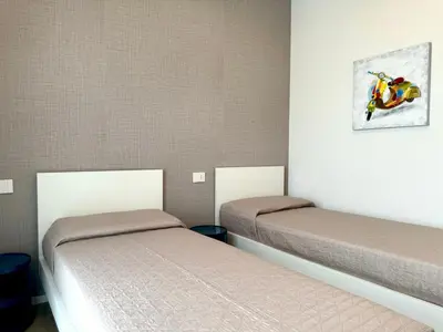 Letto o letti in una camera di Sun Village-Nuovissimo Appartamento in Residence con piscina -Lido di Jesolo Piazza Aurora