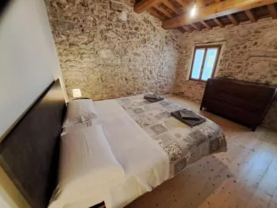 Letto o letti in una camera di Appartamento con Spa Privata e vista falesia - La Perla a Lumignano