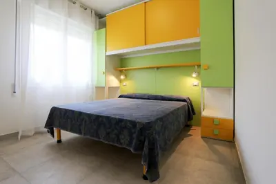 Letto o letti in una camera di Elsa bilocale vista spiaggia