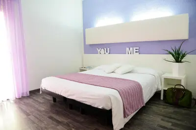 Letto o letti in una camera di Hotel Domingo
