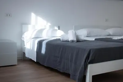 Letto o letti in una camera di Ariston Superior Fronte Mare