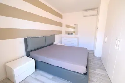 Letto o letti in una camera di Wave Village Piazza Trieste