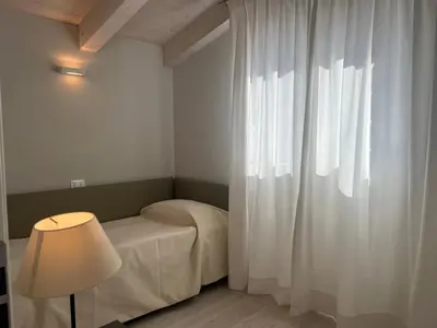Letto o letti in una camera di Villa Giulia Family Apartments- LeresidenzediJesolo