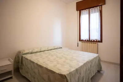 Letto o letti in una camera di Dimora Giannino e Mirella Isola di Pellestrina Ve