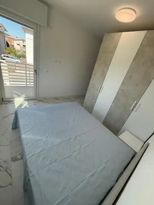 Letto o letti in una camera di WHITE APARTMENTS - Solo per famiglie- WALTERIGATO APARTMENTS