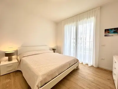Letto o letti in una camera di J Eight - Carraro Immobiliare - Family Apartments