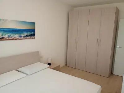 Letto o letti in una camera di Residence Florinas con piscina - Family Apartments Lido di Jesolo