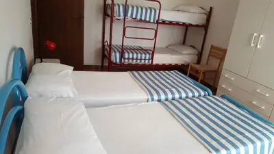 Letto o letti in una camera di RESIDENCE GALLO - WALTERIGATO Apartments PER SOLO FAMIGLIE