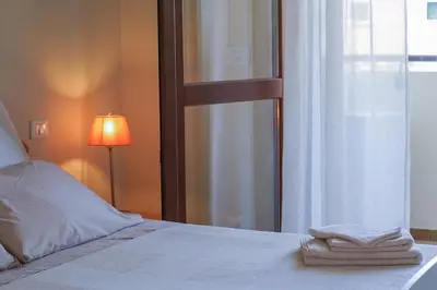 Letto o letti in una camera di Casa Origine, appartamento vista piscina, al mare