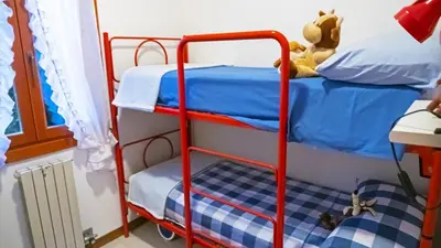 Letto o letti in una camera di Appartamento Cavallino Treporti con Piscina