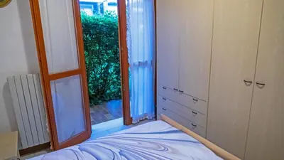 Letto o letti in una camera di Appartamento Cavallino Treporti con Piscina