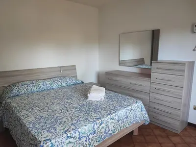 Letto o letti in una camera di Casetta STELLA MARINA PUNTA SABBIONI