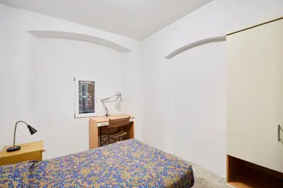 Letto o letti in una camera di Ostello AMDG