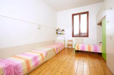 Letto o letti in una camera di Ostello AMDG