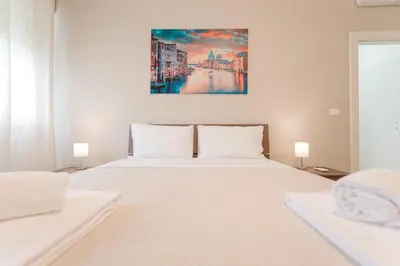Letto o letti in una camera di Elisa Flat - 15 min from Venice & Wi-Fi