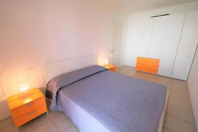 Letto o letti in una camera di Residence Borgo Paradiso posto spiaggia compreso
