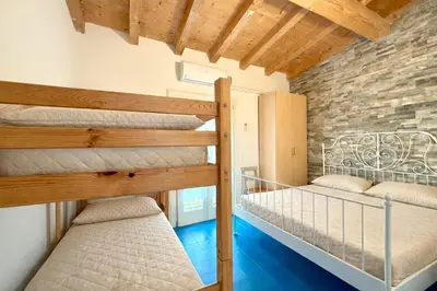 Letto o letti in una camera di Villaggio dei Gabbiani - Carraro Immobiliare - Family Apartments