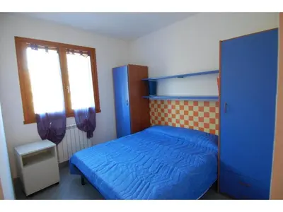 Letto o letti in una camera di Family stay in Rosolina for six guests