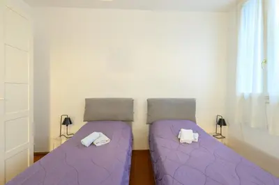 Letto o letti in una camera di GuestHost - Torre dell'Orologio Apartment Padova