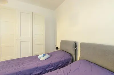Letto o letti in una camera di GuestHost - Torre dell'Orologio Apartment Padova