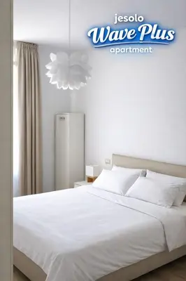 Letto o letti in una camera di Jesolo Lido Apartment with Pool Balcony & Beach Nearby