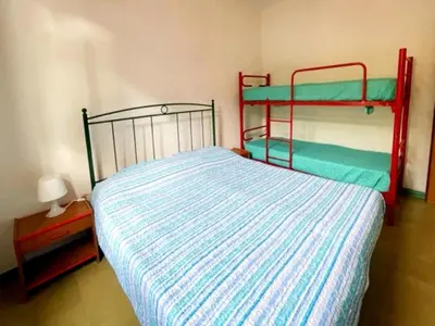 Letto o letti in una camera di Via delle Campanule Apartment for 5