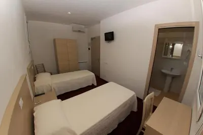 Letto o letti in una camera di Park Hotel Italia