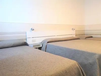 Letto o letti in una camera di Hotel Rossi