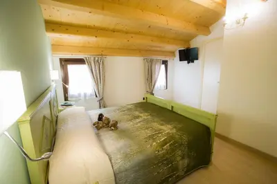 Letto o letti in una camera di Casa Sansovino
