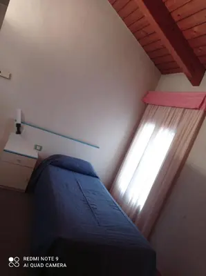 Letto o letti in una camera di Locanda Alla Stazione