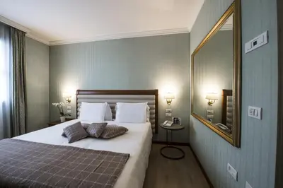 Letto o letti in una camera di Hotel Maggior Consiglio