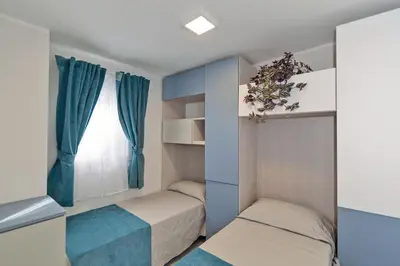 Letto o letti in una camera di Village Camping Joker