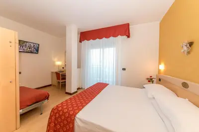 Letto o letti in una camera di Hotel Helios