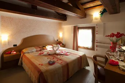 Letto o letti in una camera di Albergo Antica Corte Marchesini