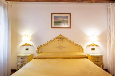 Letto o letti in una camera di Ca' Pinelli